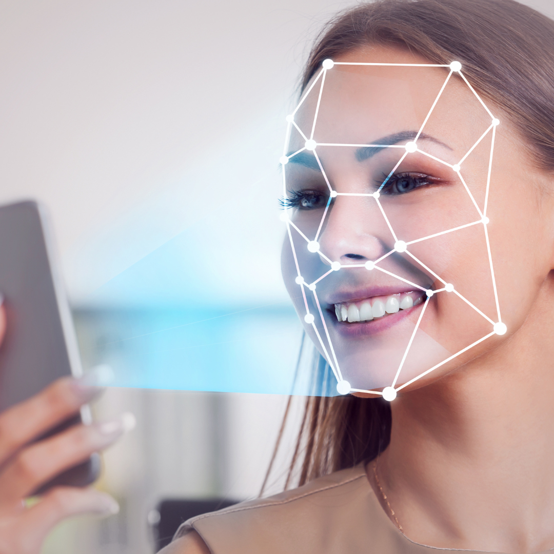 Illustration of a smartphone scanning a face with AI-powered facial recognition technology using deep machine learning.